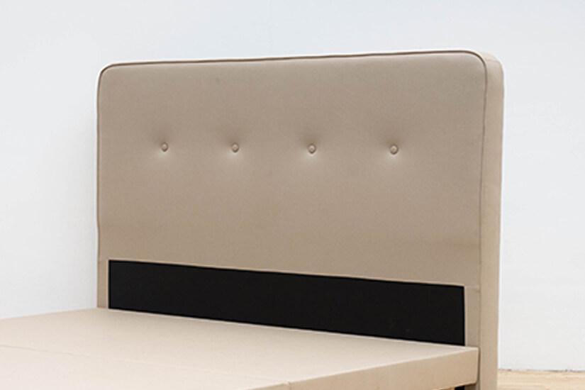 Cushioned headboard with piping details. Added versatility.