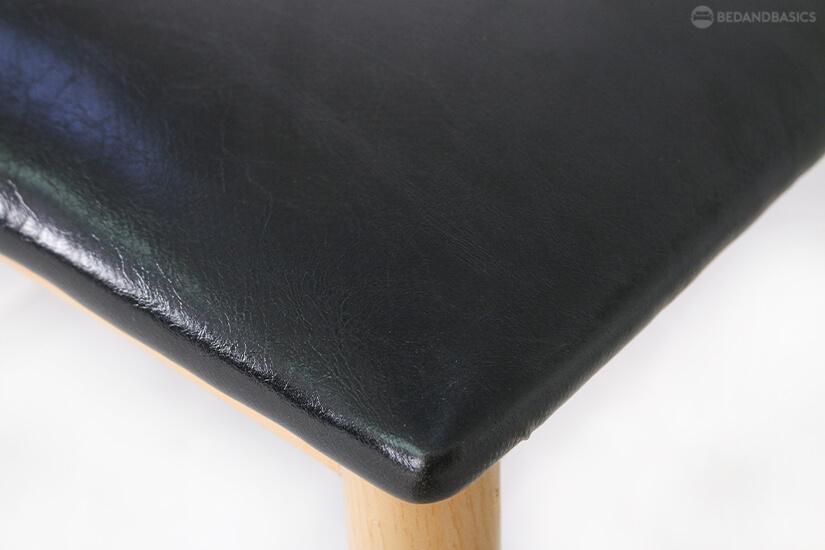 The faux leather seat is easy to clean and maintain.