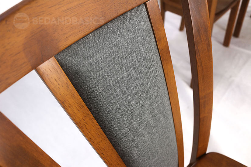 The chair has deep brown tones and a smooth finish.