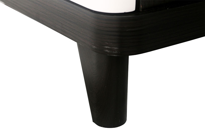 The coffee table is supported by black rounded polymer legs. 