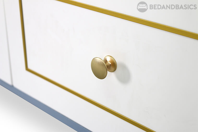 Gold colored drawer knobs.