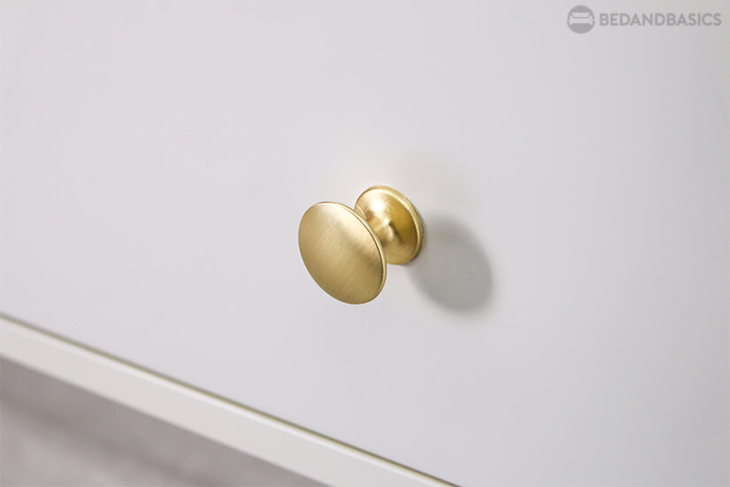 Gold finish knobs elevate the look of the coffee table.