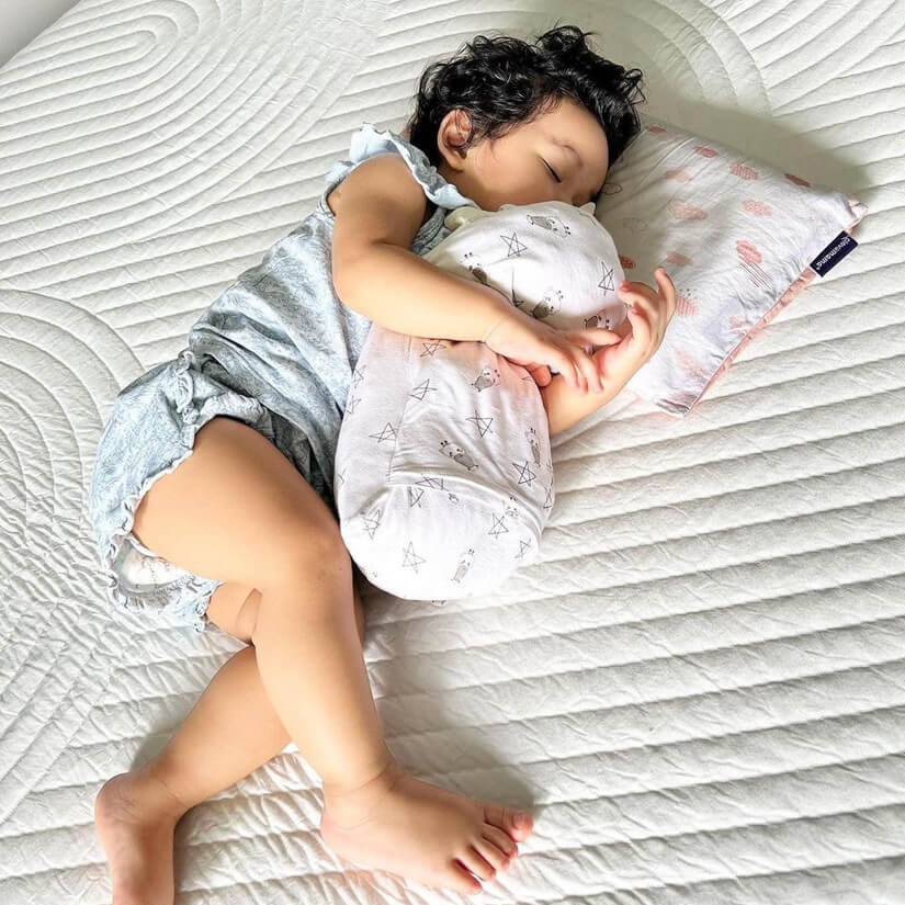 nuloft natural latex mattress lifestyle shot with sleeping baby.