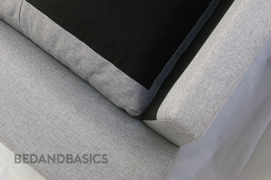 Contrasting against its fabric exterior, the sofa reveals a monochromatic palette when you flip the cushions around.