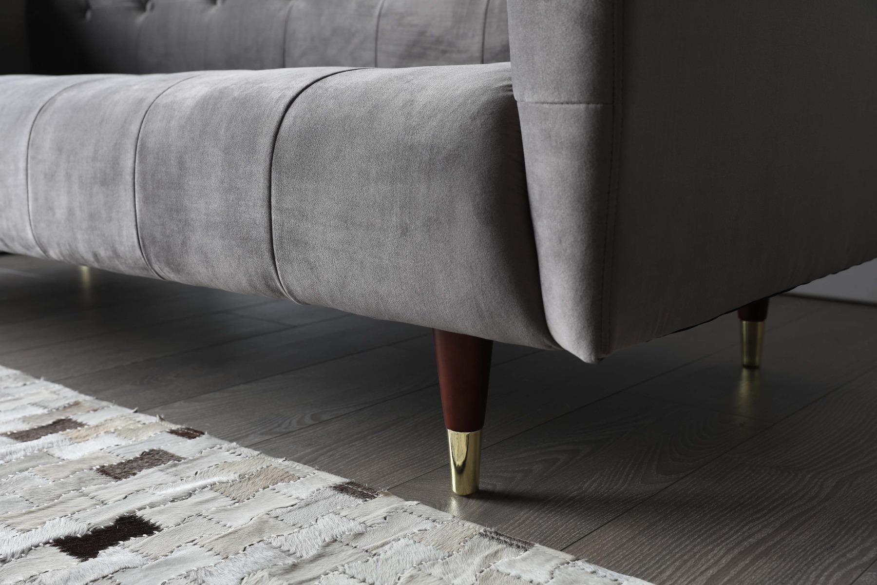 The solid wood legs are carefully handcrafted in a tapered and rounded shape, while golden capped brings a luxurious finishing to the design.