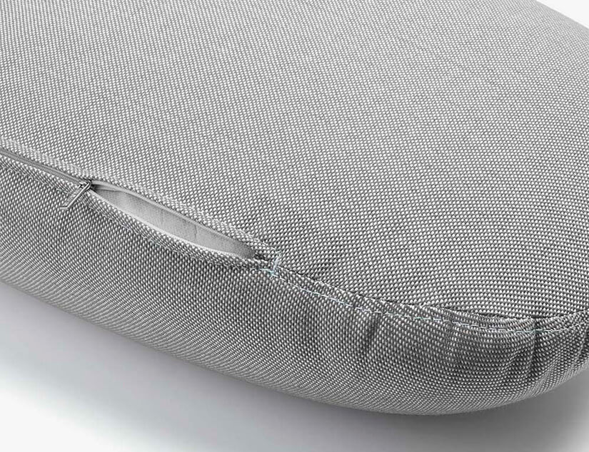 Removable cushion covers with discreet zippers.