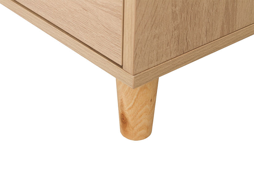 The TV stand is supported by round tapered solid wooden legs.