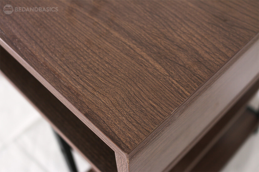Walnut coloured laminates with all-around wood swirl design adds simplicity in the design.