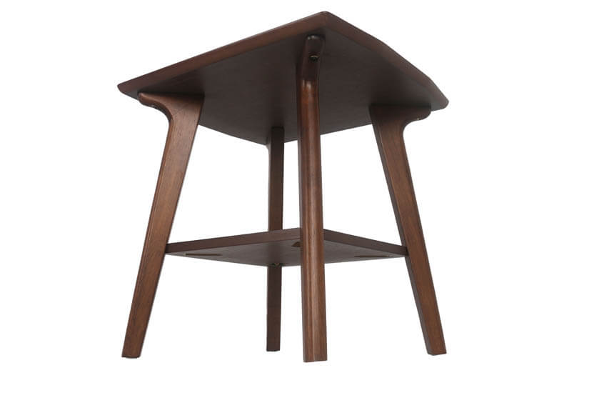 The side table is perched on tapered solid wood legs.