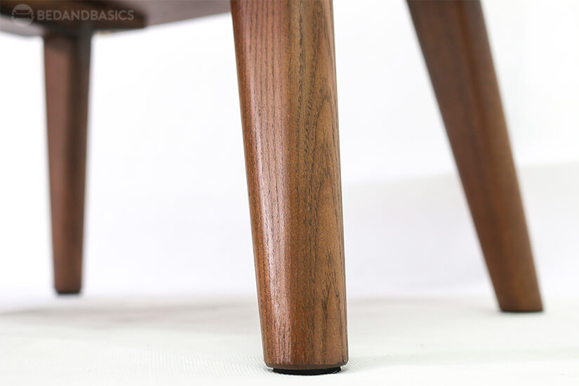Wooden tapered legs allow for easy cleaning. 