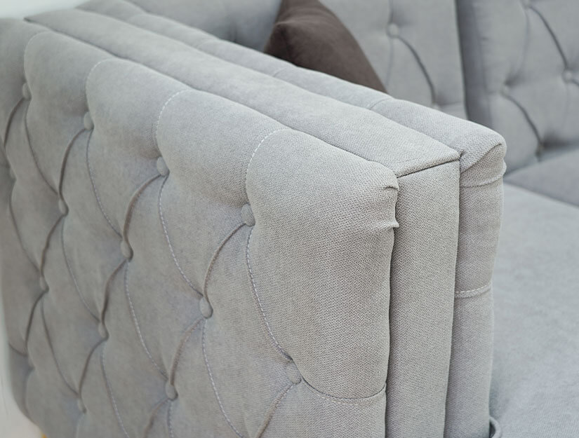 Double padded armrests with button tufting.