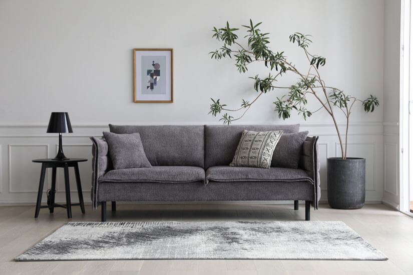 Textured fabric upholstery. Clean and polished form. Thin legs. Unique silhouette. Flatters spaces beautifully. A great sofa for lounging and lazing around.
