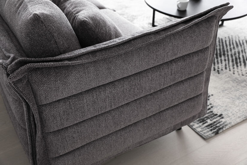 Flanged edges. Rounded corners. Clean stitches. Horizontal lines accenting the sofa’s frame. Adding dimensionality to its design. Breaking its monotony.