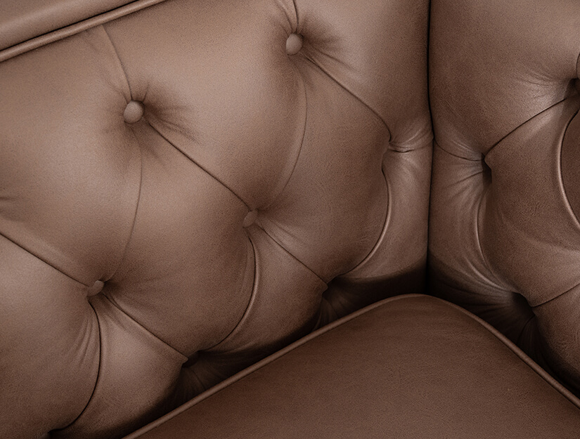 Diamond-shaped deep button tufting along the backrest and armrests. Elegant and intricate craftmanship.