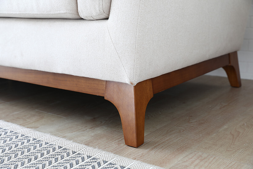 Solid wood legs. Durable design made to last. Beautiful contrast with sofa’s fabric upholstery.