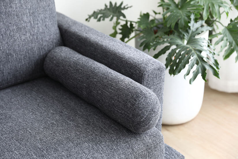 Rounded bolster that asymmetrically pairs with the matching pillows.