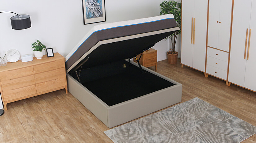 Closed wooden floor base wrapped in black woven fabric for storage. 