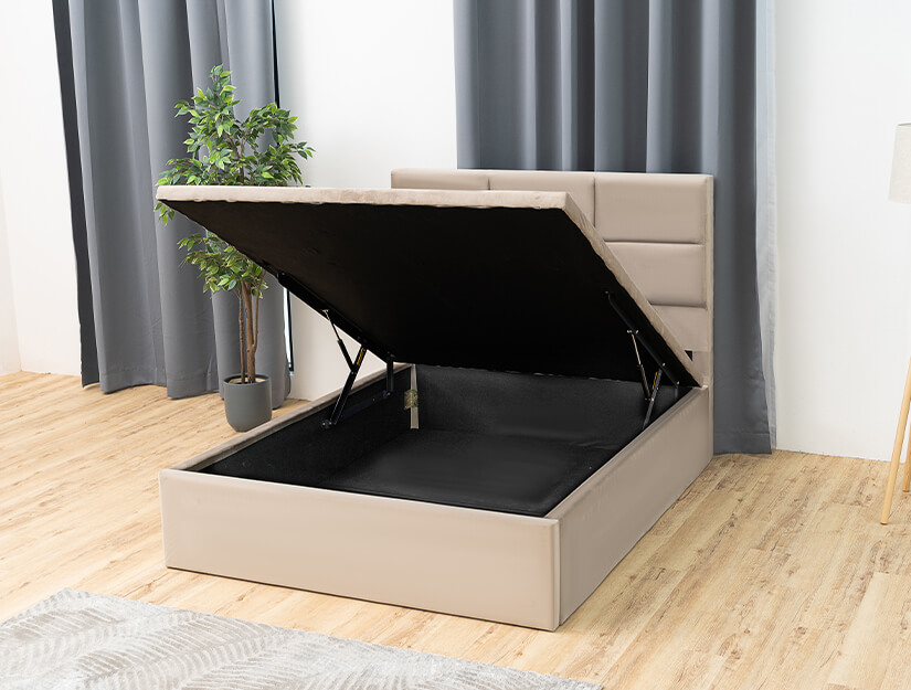 Closed wooden bed base wrapped in black woven fabric.