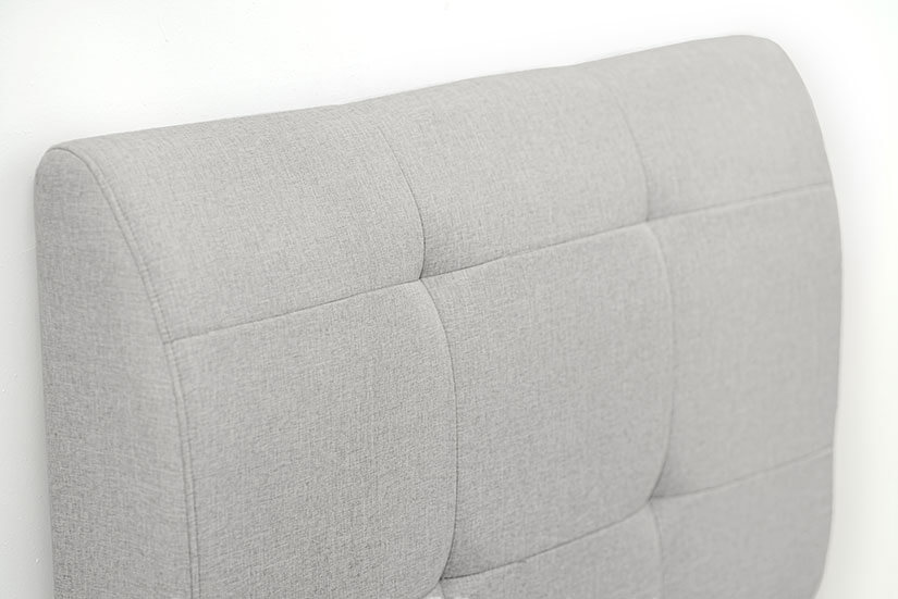 The biscuit-tufted backrest adds dimensionality to the headboard’s design.