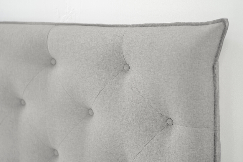 Inspired by French Country design style, the headboard has a fabric piping outline and button tuftings.