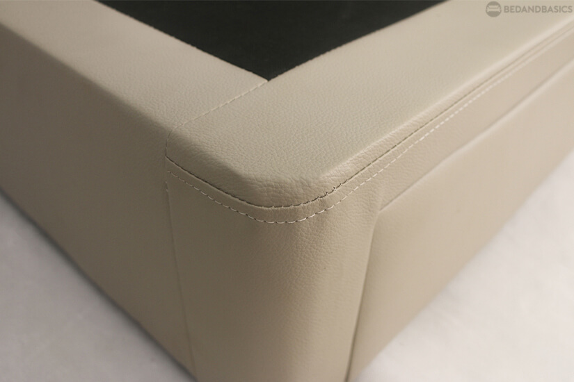 Plywood mattress support base wrapped in woven fabric.