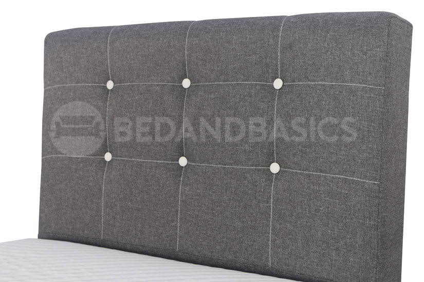 The button tufted backrest adds dimensionality to the headboard’s design.